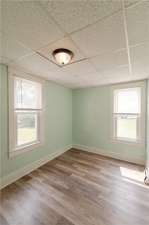 713 N 13th St, Atchison, KS 66002 - spare room with a paneled ceiling, wood finished floors, and healthy amount of natural light
