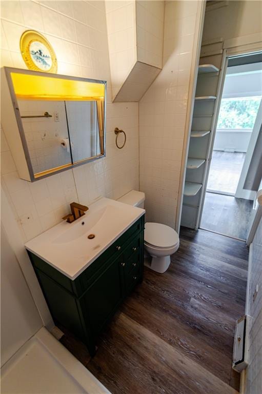 713 N 13th St, Atchison, KS 66002 - bathroom with vanity, wood finished floors, and tile walls