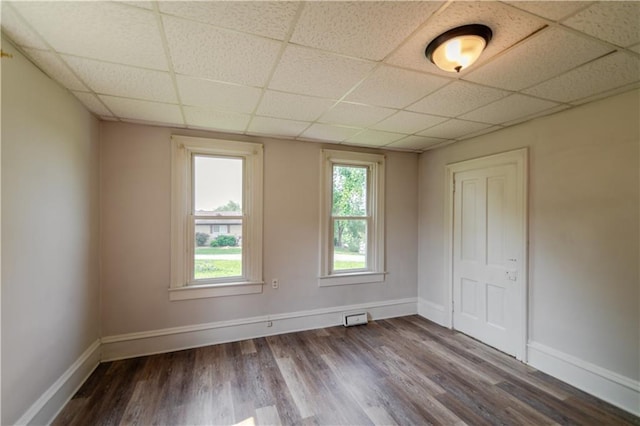 713 N 13th St, Atchison, KS 66002 - empty room featuring a paneled ceiling and dark wood-style flooring