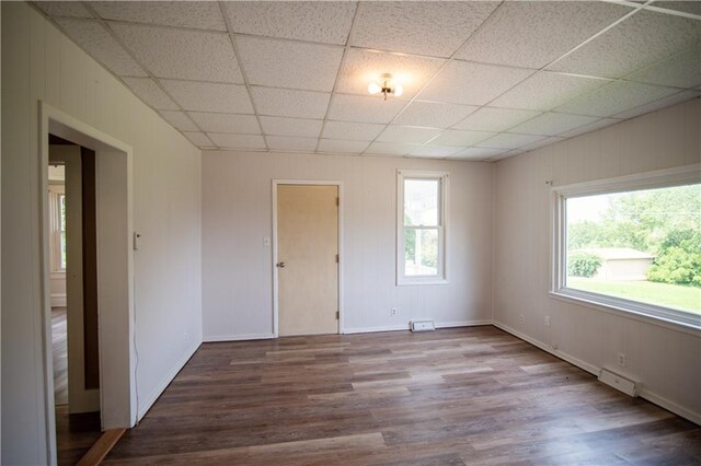 713 N 13th St, Atchison, KS 66002 - empty room featuring wood finished floors and a drop ceiling