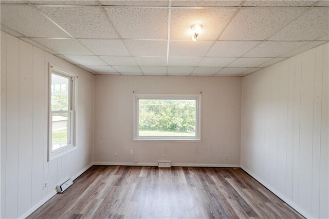 713 N 13th St, Atchison, KS 66002 - empty room with wood finished floors and a paneled ceiling