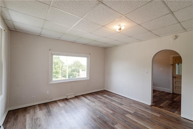 713 N 13th St, Atchison, KS 66002 - unfurnished room featuring arched walkways, a paneled ceiling, and wood finished floors