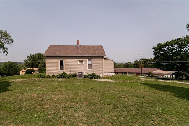 713 N 13th St, Atchison, KS 66002 - view of home's exterior with a lawn and a chimney