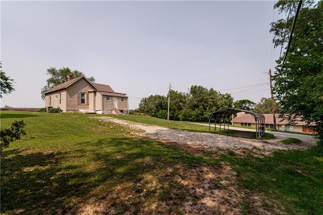 713 N 13th St, Atchison, KS 66002 - view of green lawn with a carport and driveway
