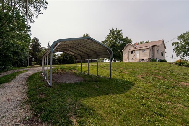 713 N 13th St, Atchison, KS 66002 - view of grassy yard with dirt driveway and a carport