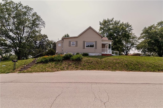 713 N 13th St, Atchison, KS 66002 - view of front of property with stairs, a porch, and a front yard