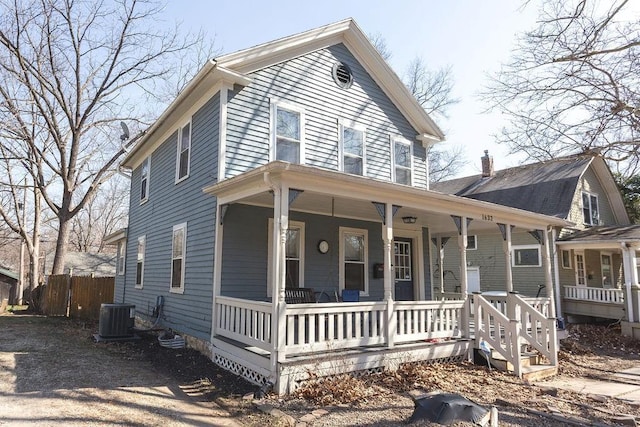 view of front facade featuring cooling unit, covered porch, and fence