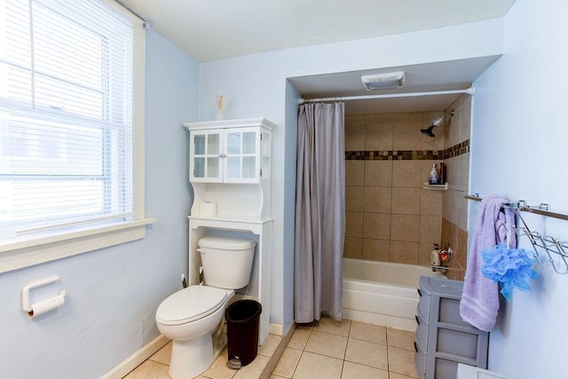 bathroom with tile patterned floors, toilet, and baseboards