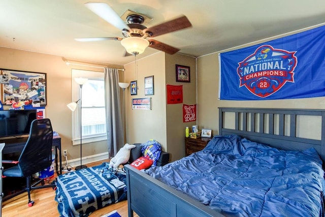 bedroom with baseboards, wood finished floors, and a ceiling fan