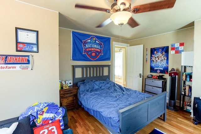 bedroom with wood finished floors and a ceiling fan