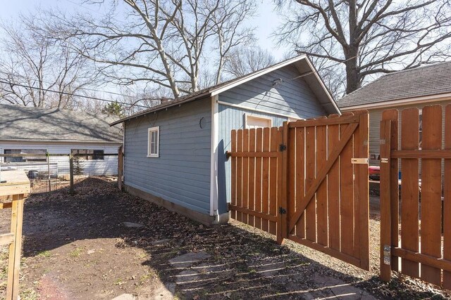 view of side of property with a gate and fence