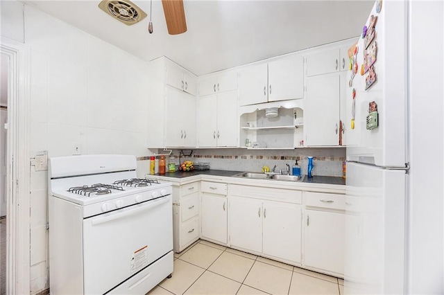 kitchen featuring a sink, decorative backsplash, white appliances, a ceiling fan, and open shelves