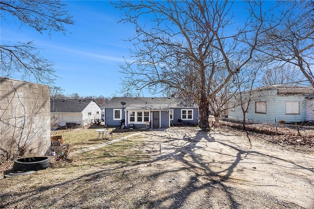 back of house featuring fence