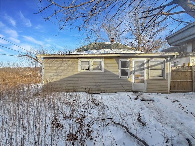 view of snowy exterior with fence