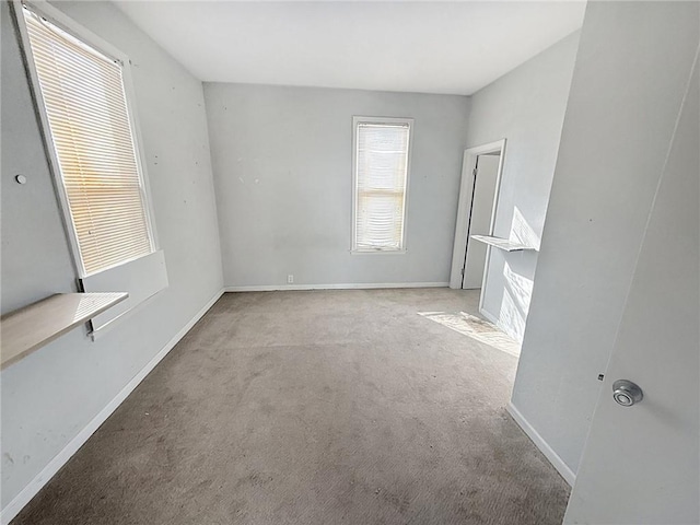 unfurnished bedroom featuring baseboards and carpet floors