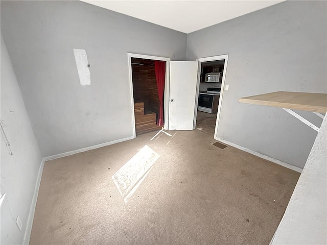 unfurnished bedroom with visible vents, carpet floors, and baseboards