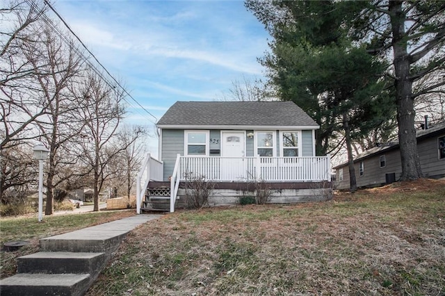 view of front of property featuring covered porch and a shingled roof