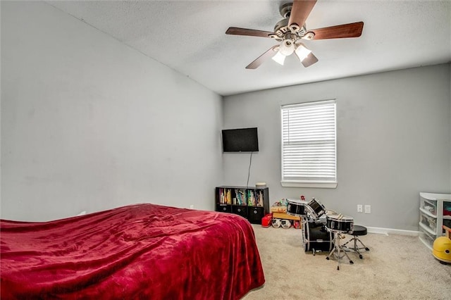 bedroom featuring ceiling fan, carpet flooring, baseboards, and a textured ceiling