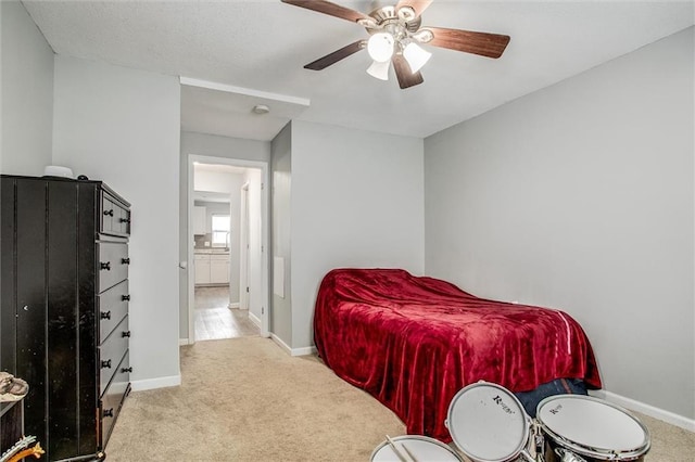 carpeted bedroom featuring a ceiling fan and baseboards