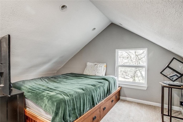 bedroom with carpet flooring, a textured ceiling, baseboards, and vaulted ceiling