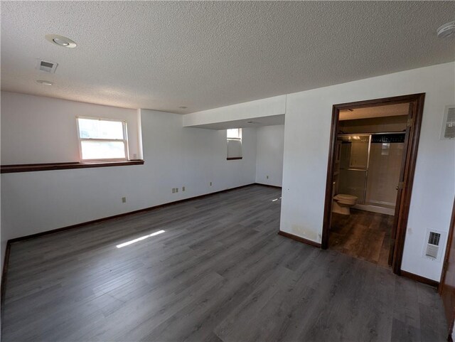 1900 SE 6th Ter, Lees Summit, MO 64063 - basement with a textured ceiling, wood finished floors, and baseboards