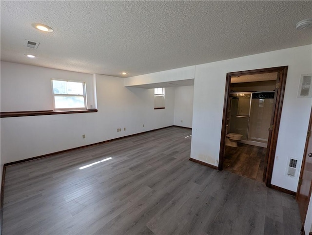 1900 SE 6th Ter, Lees Summit, MO 64063 - basement featuring wood finished floors, a textured ceiling, baseboards, and recessed lighting