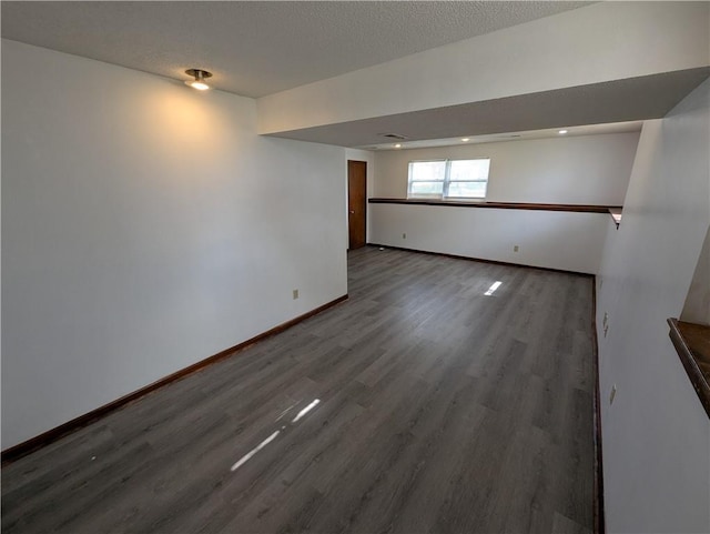 1900 SE 6th Ter, Lees Summit, MO 64063 - below grade area featuring wood finished floors, baseboards, and a textured ceiling