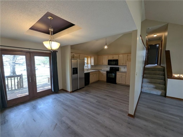 1900 SE 6th Ter, Lees Summit, MO 64063 - kitchen featuring black appliances, baseboards, cream cabinetry, french doors, and vaulted ceiling