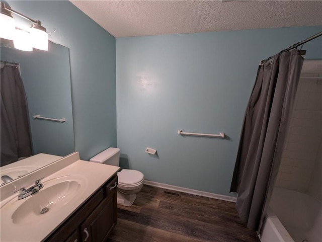 1900 SE 6th Ter, Lees Summit, MO 64063 - bathroom with a textured ceiling, wood finished floors, toilet, vanity, and shower / bath combo with shower curtain