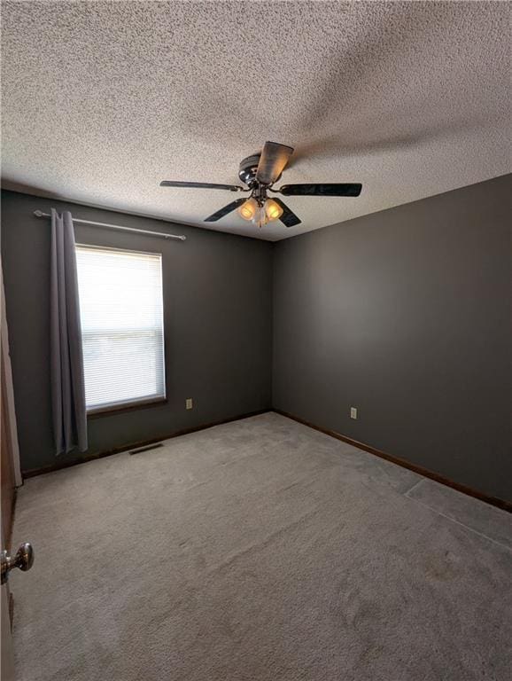 1900 SE 6th Ter, Lees Summit, MO 64063 - unfurnished room featuring ceiling fan, a textured ceiling, and carpet floors