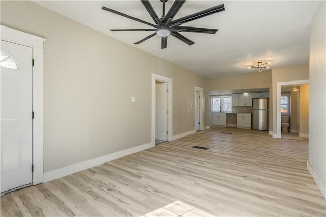 unfurnished living room featuring visible vents, ceiling fan, baseboards, and light wood-style floors