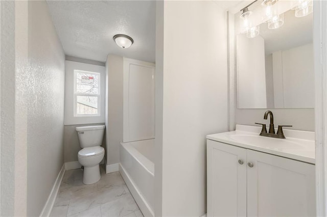 full bath with vanity, baseboards, a textured ceiling, toilet, and marble finish floor