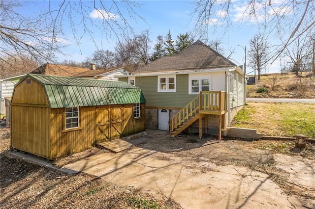 back of property with a barn and an outdoor structure