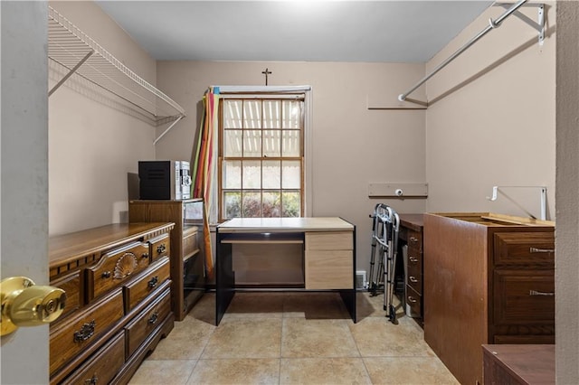 spacious closet with light tile patterned floors