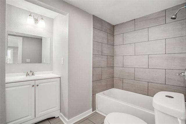 full bathroom featuring vanity, washtub / shower combination, baseboards, tile patterned flooring, and toilet