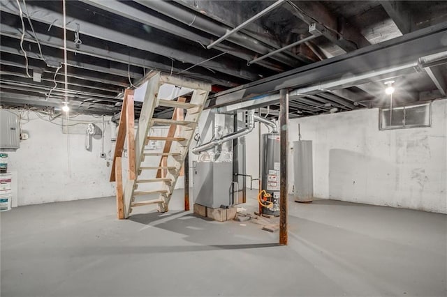 unfinished basement featuring stairway, heating unit, and water heater