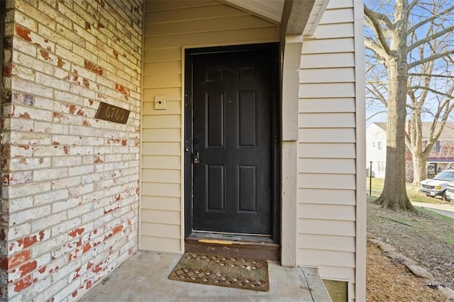 view of exterior entry with brick siding