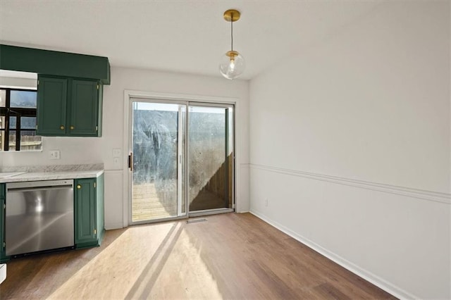 unfurnished dining area featuring baseboards and wood finished floors