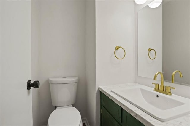 half bathroom with toilet and vanity