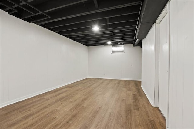 finished basement featuring baseboards and wood finished floors