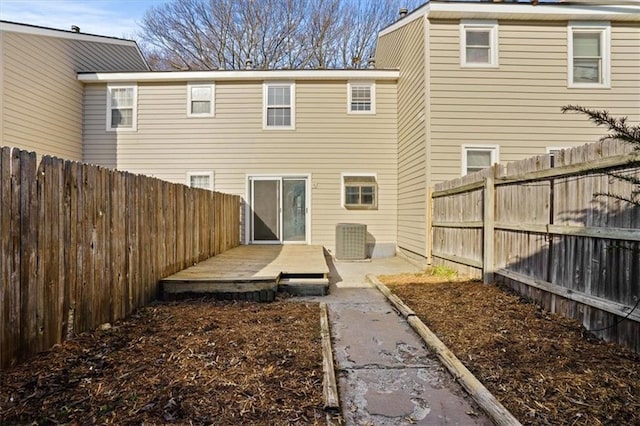 rear view of property with a deck and a fenced backyard