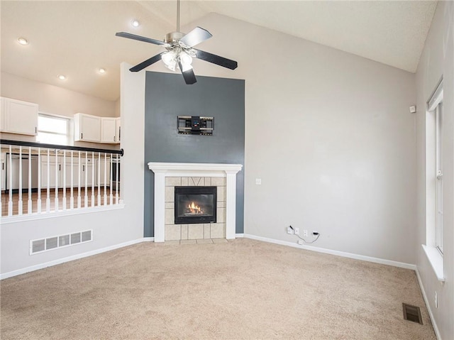 unfurnished living room featuring visible vents, a fireplace, ceiling fan, and vaulted ceiling