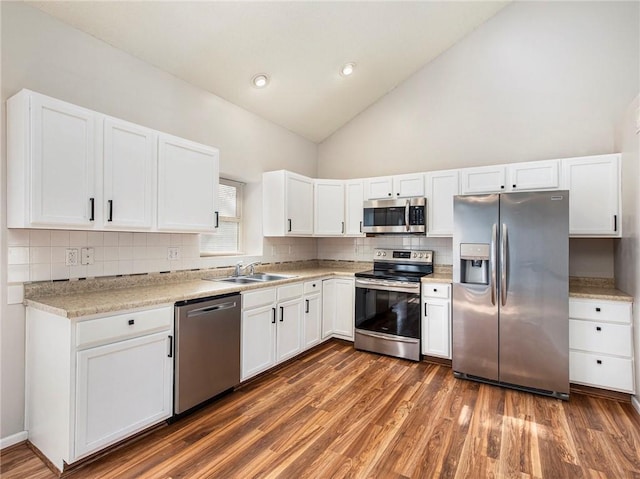 kitchen featuring dark wood-style flooring, a sink, light countertops, appliances with stainless steel finishes, and white cabinetry