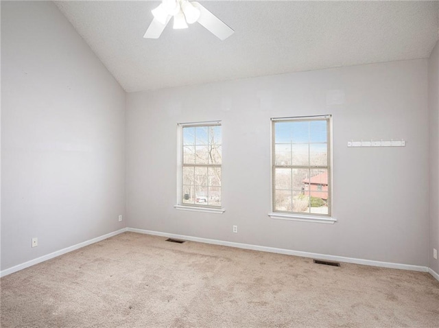 carpeted spare room featuring a textured ceiling, a ceiling fan, visible vents, and baseboards