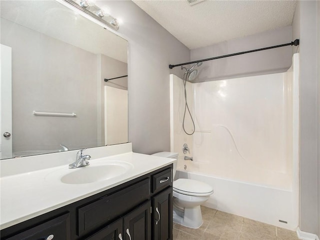 bathroom with vanity, a textured ceiling, bathing tub / shower combination, toilet, and tile patterned floors