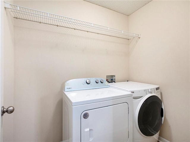 clothes washing area with washer and dryer and laundry area