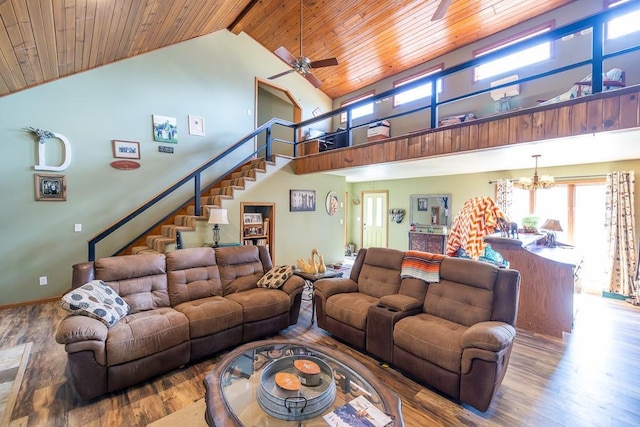 living area with high vaulted ceiling, ceiling fan with notable chandelier, wood finished floors, stairway, and wooden ceiling