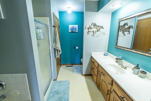 full bath with baseboards, toilet, a stall shower, and vanity