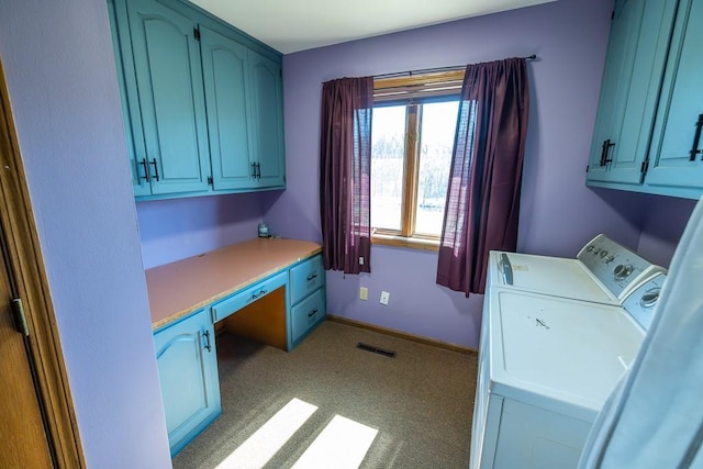 clothes washing area featuring baseboards, cabinet space, visible vents, and washer and clothes dryer