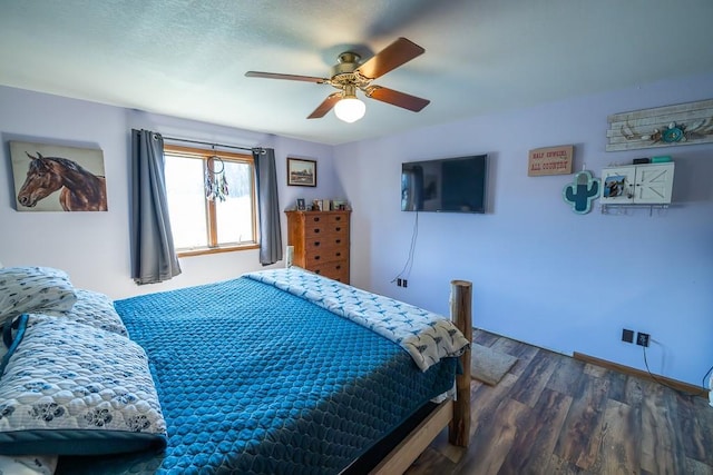 bedroom featuring a ceiling fan and dark wood-style flooring